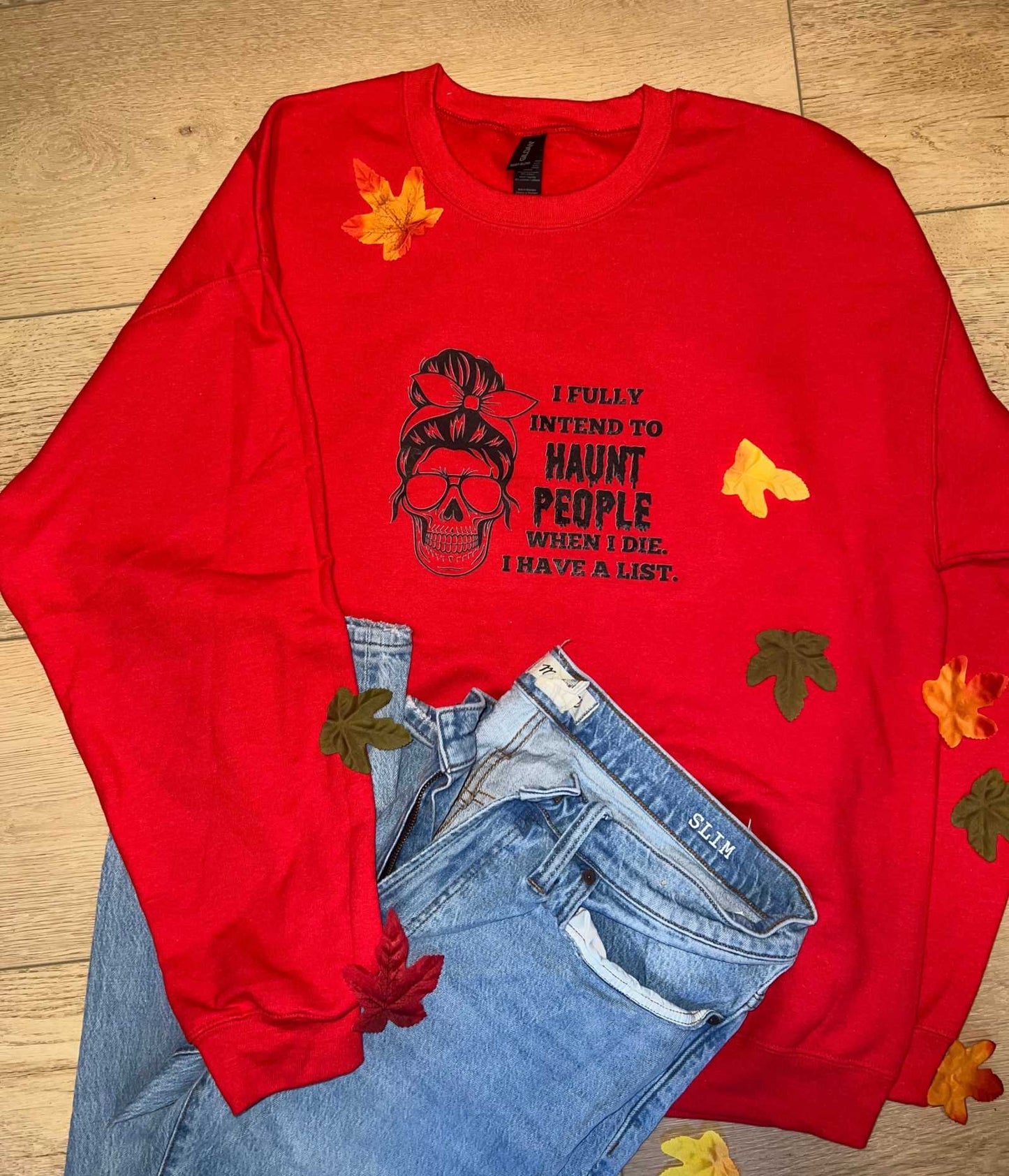 Red "I intend to Haunt People" graphic Halloween T-shirt with skull design.